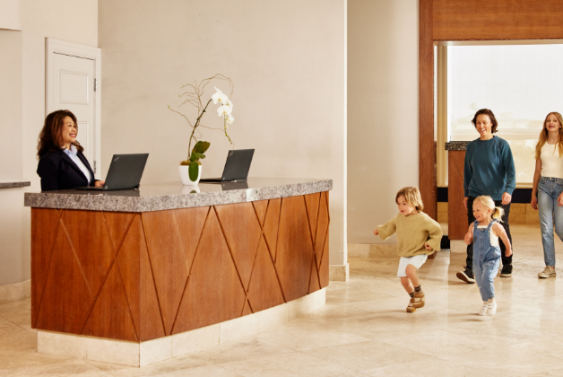 Family walking up to a hotel front desk